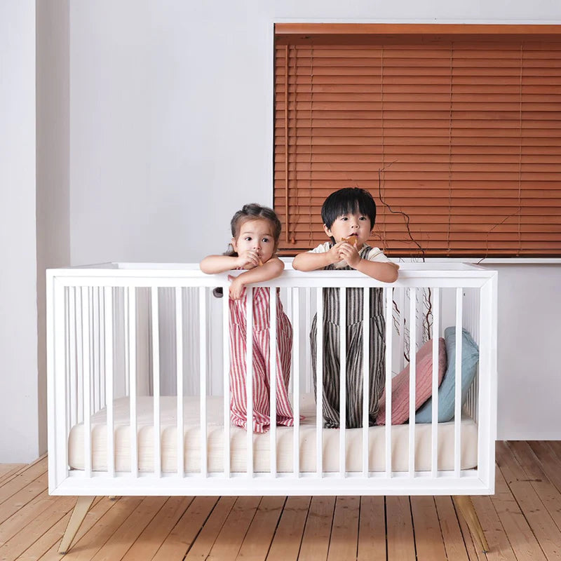 Two kids in the best baby crib in Hong Kong by Little Hushies Hush Home