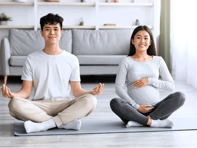 A pregnant women and her husband practicing meditation. This blog breaks down how pregnancy may affect the sleep quality in pregnant women.