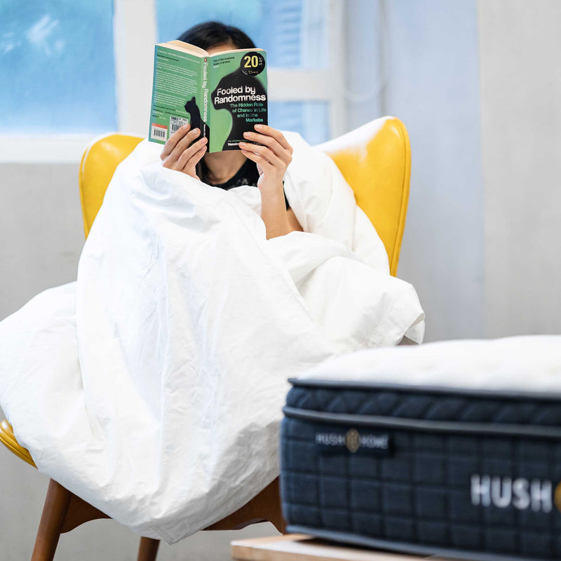 A women reading book comfortably with the best duvet in Hong Kong by Hush Home 